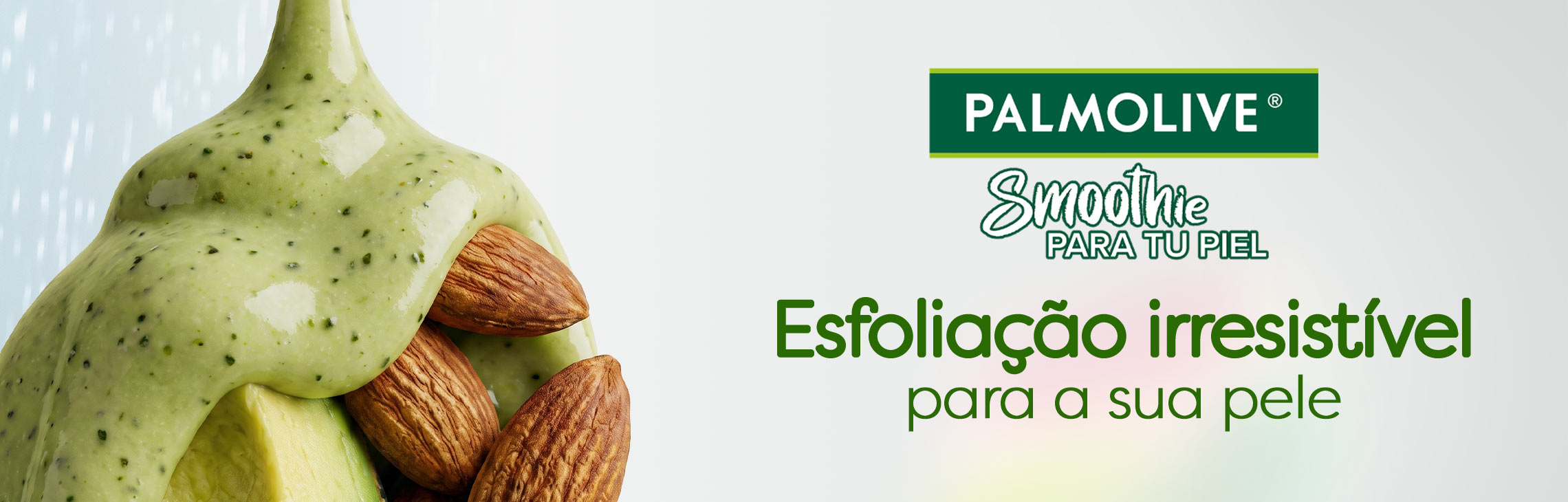 Textura close-up do esfoliante Palmolive Smoothie de amêndoa, abacate e leite sob a água, com partículas esfoliantes visíveis. Esfoliação irresistível para a sua pele.